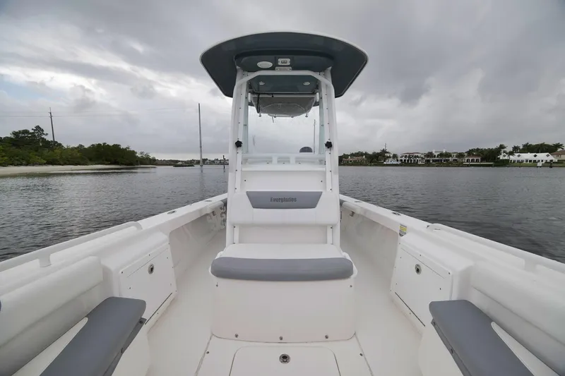 Slide: The Image of 2018 Everglades 243 Center Console boat on calm water under cloudy skies. - 50