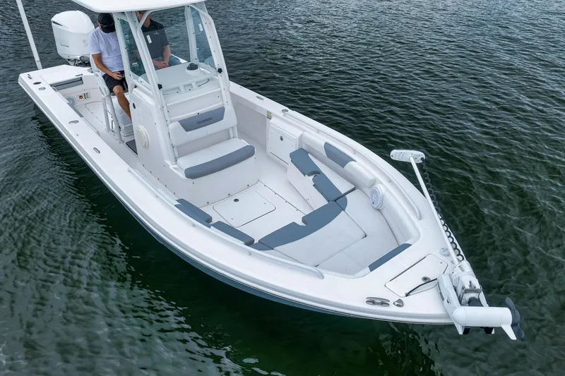 Slide: The Image of 2018 Everglades 243 Center Console boat on water, featuring sleek design and spacious seating. - 8