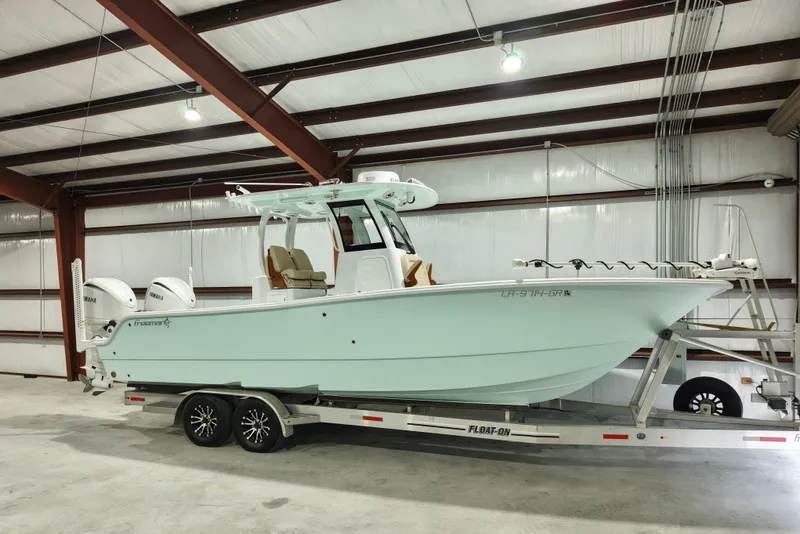 Slide: The Image of 2024 Freeman 28 boat on trailer in indoor storage facility. - 1
