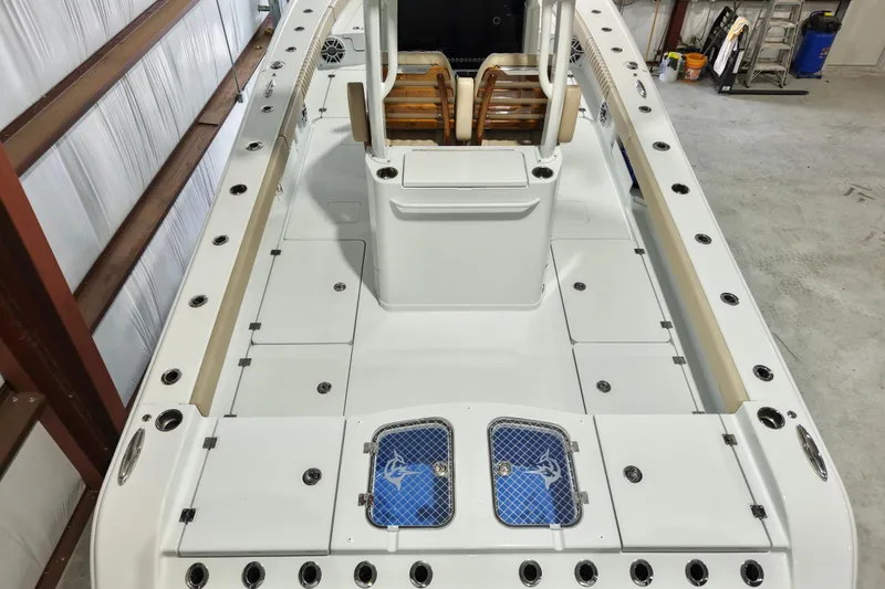 Slide: The Image of 2024 Freeman 28 boat interior with spacious deck and seating, featuring modern design and storage compartments. - 13