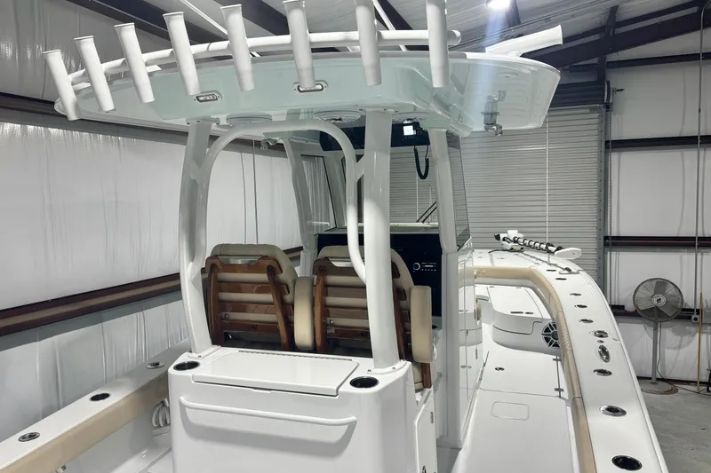 Slide: The Image of 2024 Freeman 28 boat interior with seating and rod holders in a storage facility. - 16