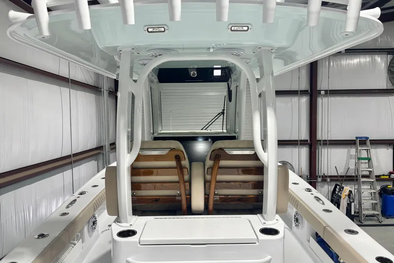 Slide: The Image of 2024 Freeman 28 boat interior with seating and storage in a warehouse setting. - 17