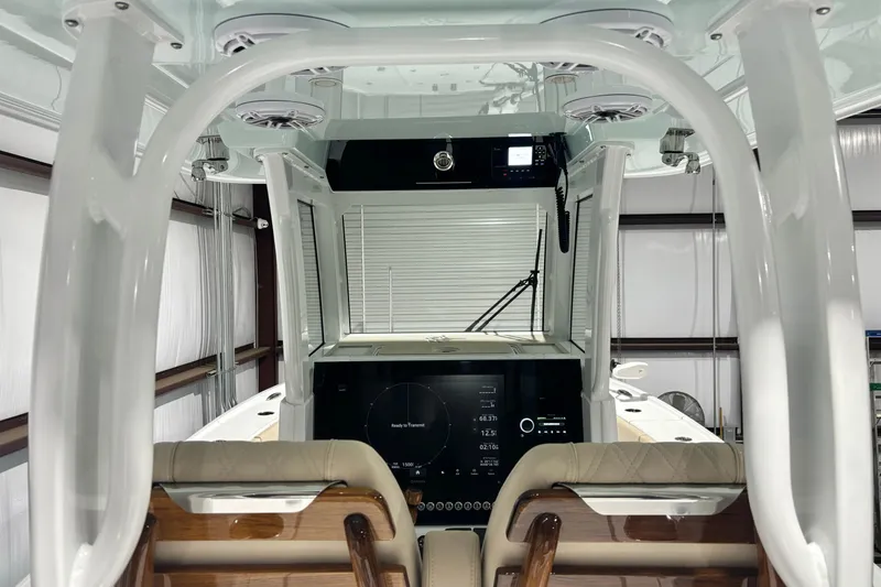 Slide: The Image of Interior view of a 2024 Freeman 28 boat with modern dashboard and seating. - 18