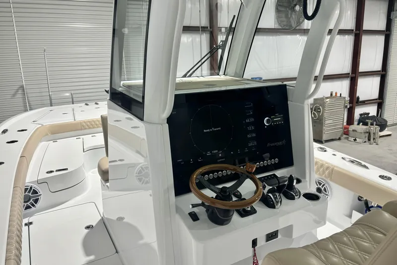 Slide: The Image of 2024 Freeman 28 boat interior with modern dashboard and steering wheel in a garage setting. - 20