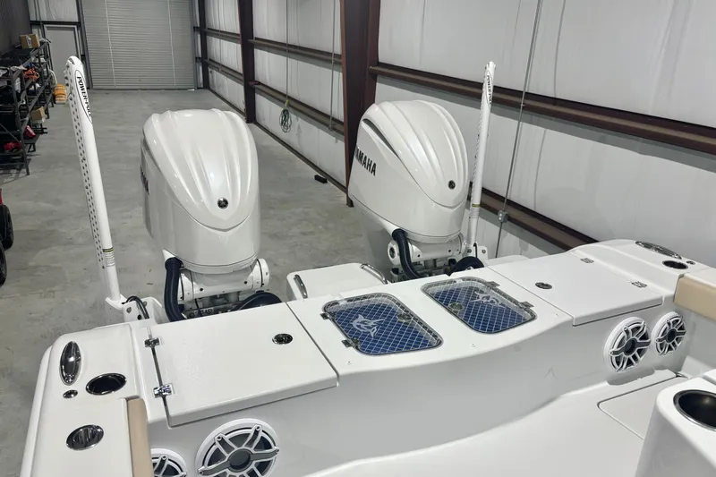 Slide: The Image of 2024 Freeman 28 boat with dual Yamaha outboard engines in a garage. - 21
