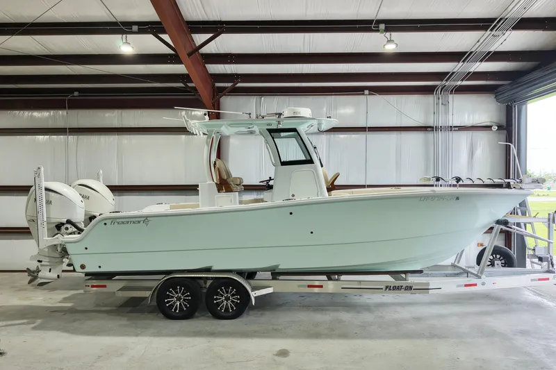 Slide: The Image of 2024 Freeman 28 boat on trailer in indoor storage facility. - 4