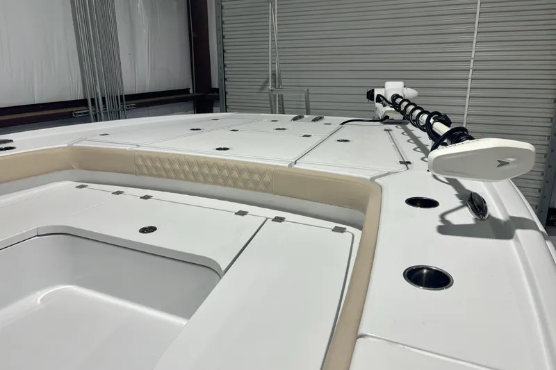 Slide: The Image of 2024 Freeman 28 boat deck with storage compartments and mounted equipment in a garage setting. - 6