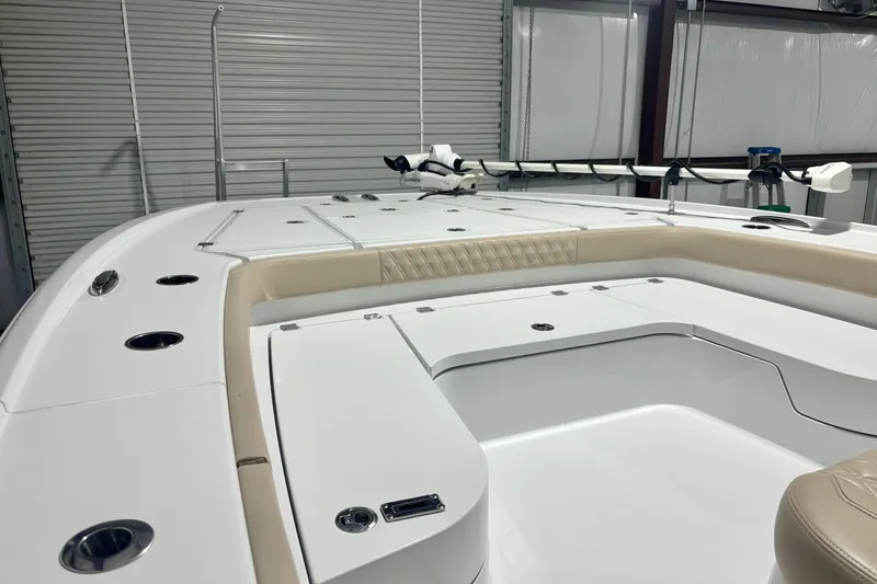 Slide: The Image of 2024 Freeman 28 boat interior with sleek white design and modern features in a garage setting. - 8