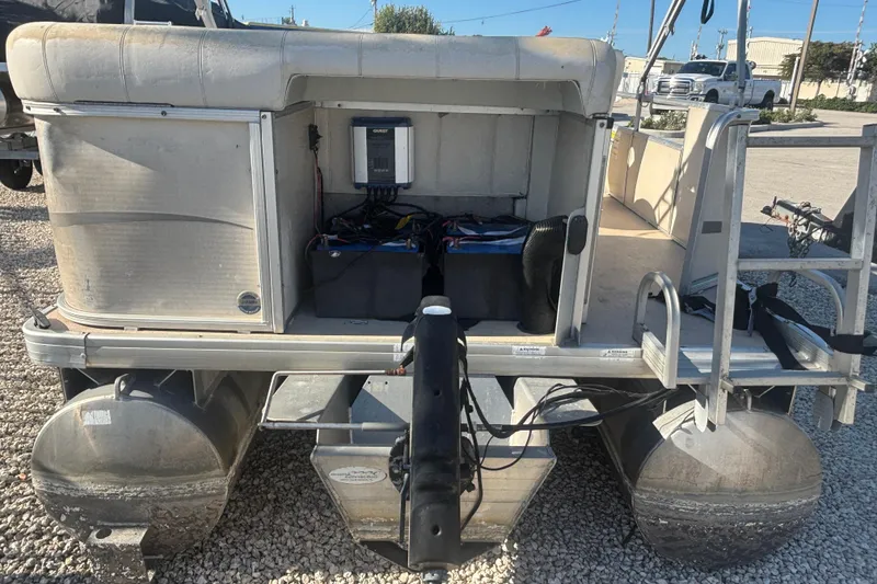 Slide: The Image of 2007 Sweetwater 1880 C pontoon boat rear view with visible engine and seating area. - 3