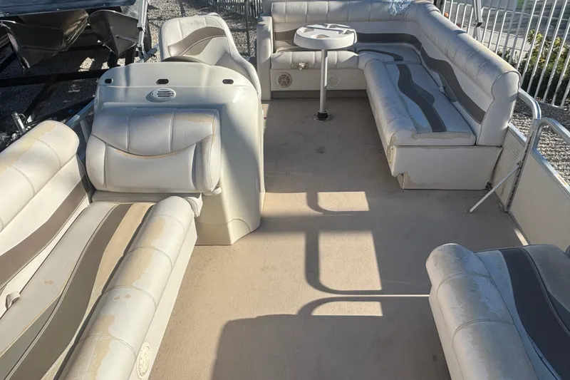 Slide: The Image of Interior of a 2007 Sweetwater 1880 C pontoon boat with beige seating. - 4