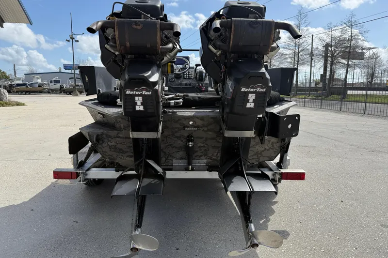 Slide: The Image of 2018 Gator Tail Extreme Series 2060cc boat with dual motors, parked outdoors. - 5