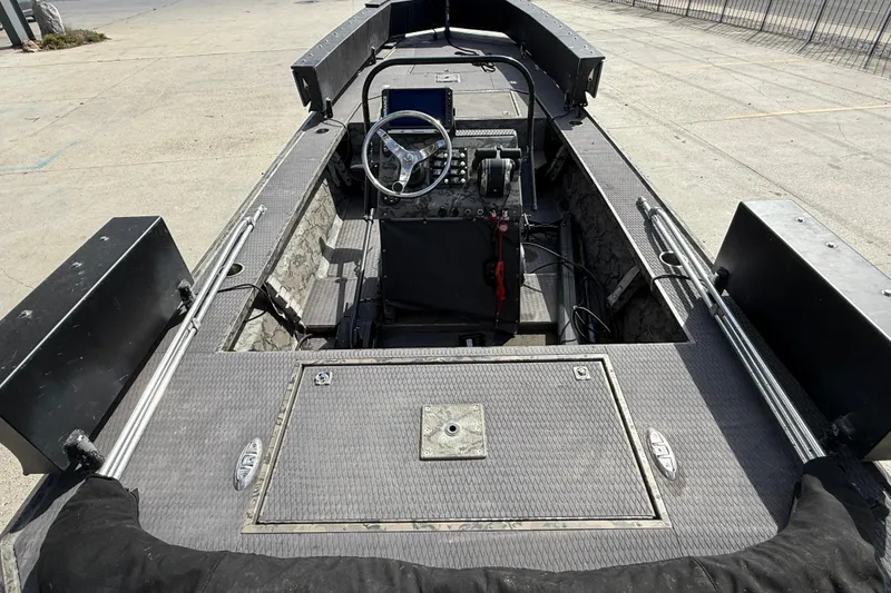 Slide: The Image of 2018 Gator Tail Extreme Series 2060cc boat interior with steering console and storage compartments. - 7