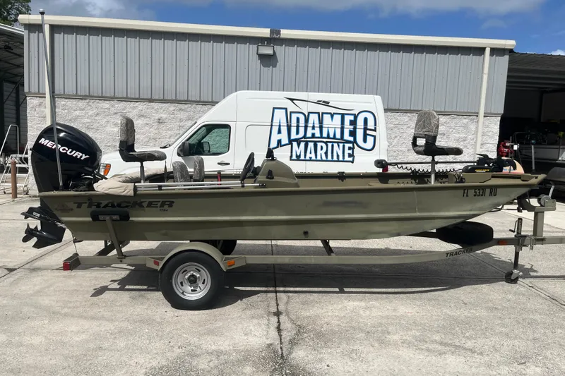 The Image of 2011 Tracker Grizzly 1754 Side Console boat on trailer, parked at Adamec Marine. - 1