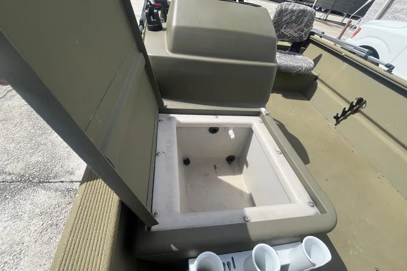 Slide: The Image of 2011 Tracker Grizzly 1754 Side Console boat interior with open storage compartment. - 10