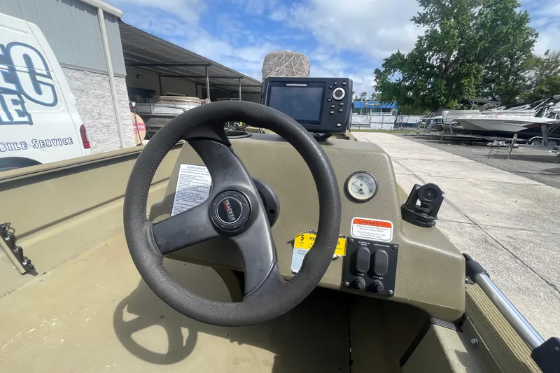 Slide: The Image of Steering console of 2011 Tracker Grizzly 1754 boat with navigation equipment. - 13