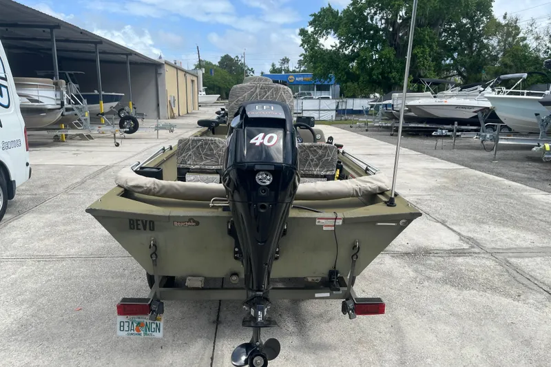 Slide: The Image of 2011 Tracker Grizzly 1754 Side Console boat with 40 HP EFI motor in a marina. - 3