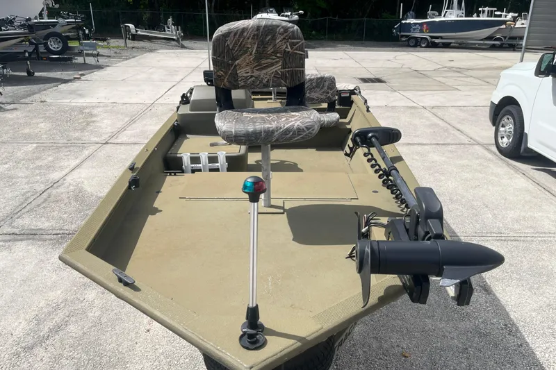 Slide: The Image of 2011 Tracker Grizzly 1754 Side Console boat with camo seats and trolling motor. - 7