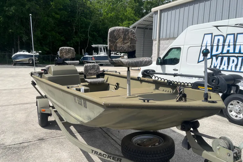 Slide: The Image of 2011 Tracker Grizzly 1754 Side Console boat on trailer, parked outdoors. - 8