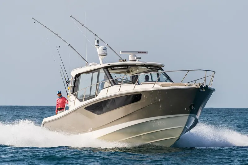 The Image of Manufacturer Provided Image: 2026 Boston Whaler 405 Conquest cruising on open water, showcasing sleek design and fishing rods. - 0