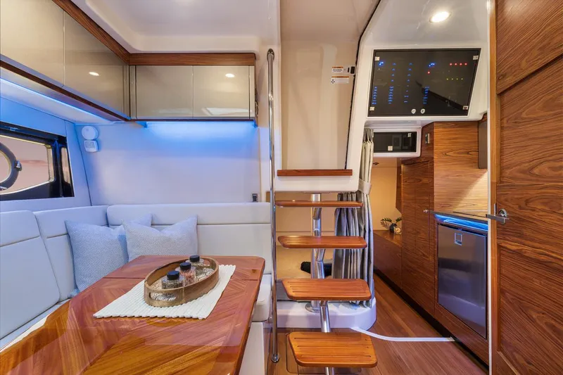 Slide: The Image of Manufacturer Provided Image: Luxurious interior of 2026 Boston Whaler 405 Conquest yacht with modern wood finishes. - 13