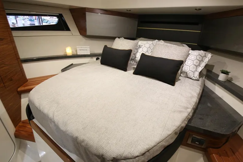 Slide: The Image of Manufacturer Provided Image: Luxurious cabin interior of 2026 Boston Whaler 405 Conquest with cozy bedding and modern decor. - 19