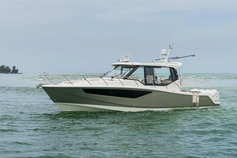 Slide: The Image of Manufacturer Provided Image: 2026 Boston Whaler 405 Conquest boat cruising on open water. - 5