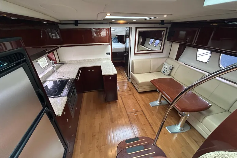 Slide: The Image of Luxurious interior of 2009 Sea Ray 480 Sundancer yacht with kitchen and seating area. - 10