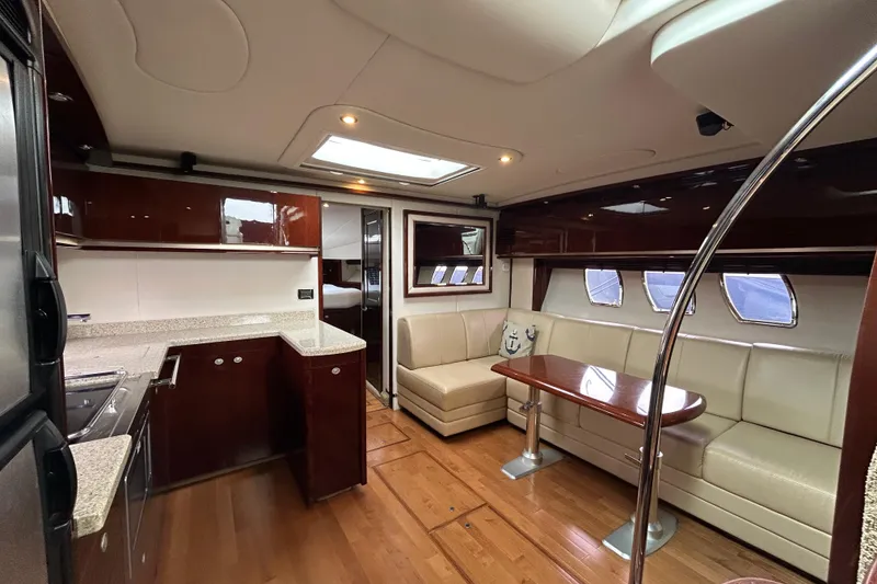 Slide: The Image of Luxurious interior of 2009 Sea Ray 480 Sundancer yacht with modern kitchen and seating area. - 11