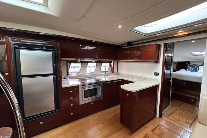 Slide: The Image of Luxurious kitchen interior of 2009 Sea Ray 480 Sundancer yacht with modern appliances. - 12