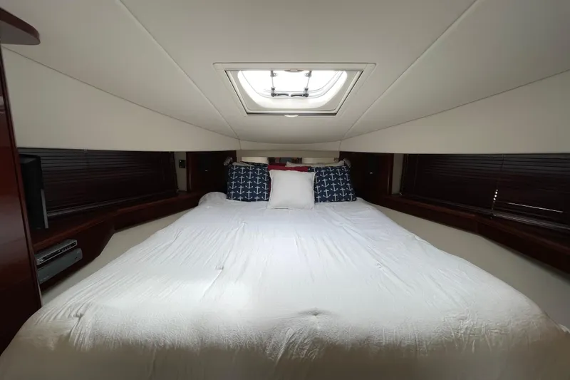 Slide: The Image of Luxurious bedroom interior of 2009 Sea Ray 480 Sundancer yacht with skylight and nautical decor. - 15