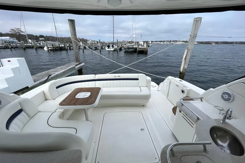 Slide: The Image of 2009 Sea Ray 480 Sundancer yacht interior with seating and table, docked at marina. - 6