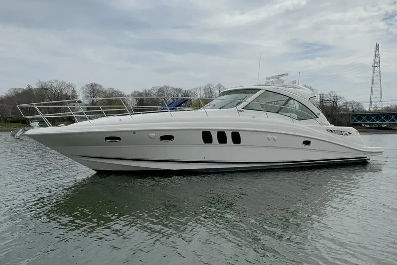 The Image of 2009 Sea Ray 480 Sundancer yacht on calm water, overcast sky background. - 0