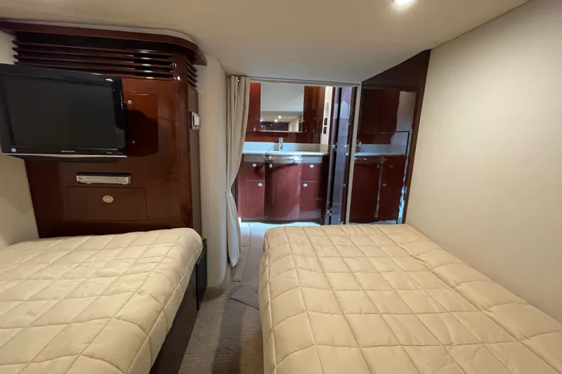 Slide: The Image of Interior cabin of 2009 Sea Ray 480 Sundancer with twin beds and TV. - 22