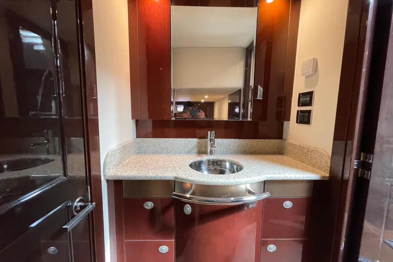 Slide: The Image of Luxurious bathroom interior of 2009 Sea Ray 480 Sundancer yacht with sleek wood cabinetry. - 23