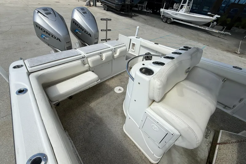 Slide: The Image of 2006 Triton 2690 CC boat interior with Honda outboard engines, featuring seating and storage. - 11