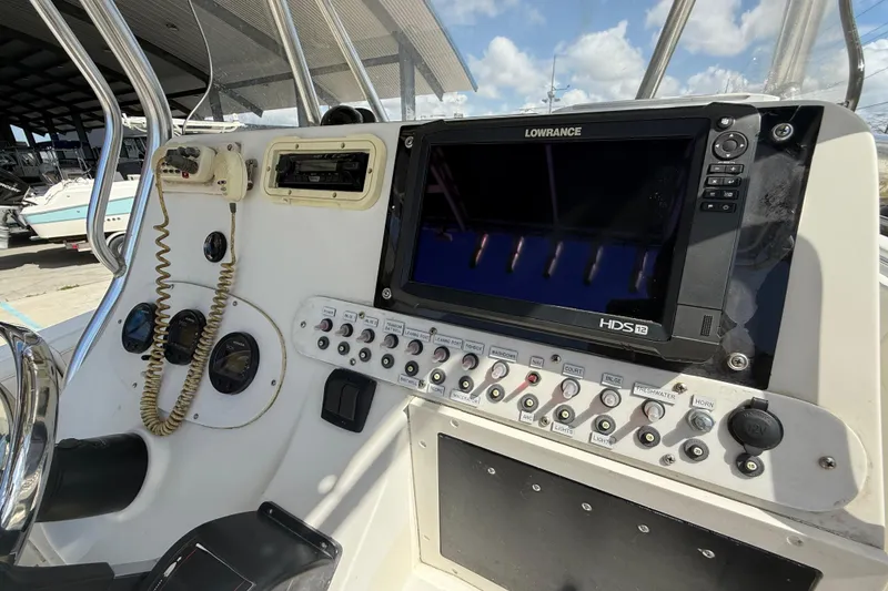 Slide: The Image of 2006 Triton 2690 CC boat console with Lowrance HDS12 display and control panel. - 14