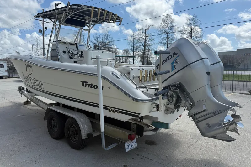 Slide: The Image of 2006 Triton 2690 CC boat on trailer with dual Honda outboard motors. - 4