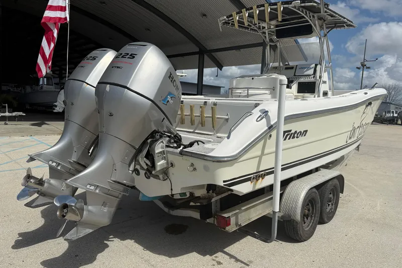 Slide: The Image of 2006 Triton 2690 CC boat with dual Honda 225 engines on a trailer. - 6