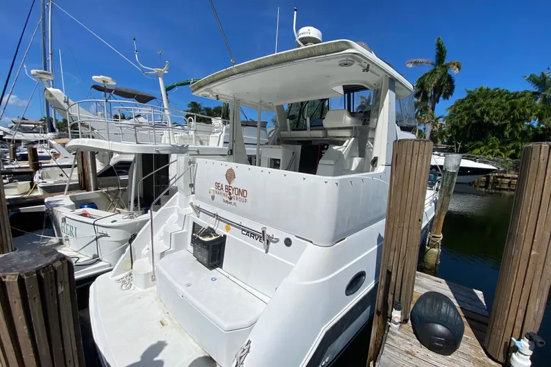 Slide: The Image of 2003 Carver 356 Motor Yacht docked at marina under clear blue sky. - 11