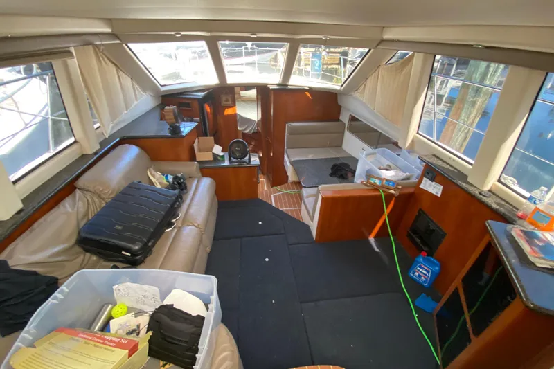 Slide: The Image of Interior of 2003 Carver 356 Motor Yacht with seating, windows, and storage boxes. - 17