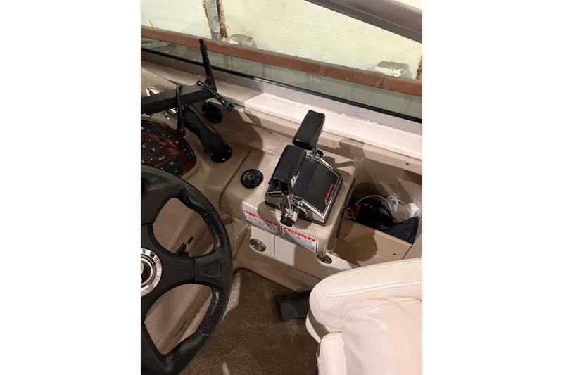 The Image of 2004 Searay 280 Sundancer helm with steering wheel and throttle controls. - 1