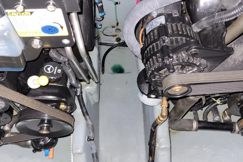 Slide: The Image of Engine compartment of a 2004 Searay 280 Sundancer boat, showing mechanical components. - 14