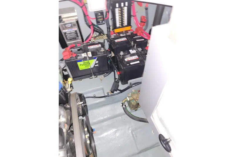 Slide: The Image of Engine compartment of a 2004 Searay 280 Sundancer with dual batteries and wiring. - 15
