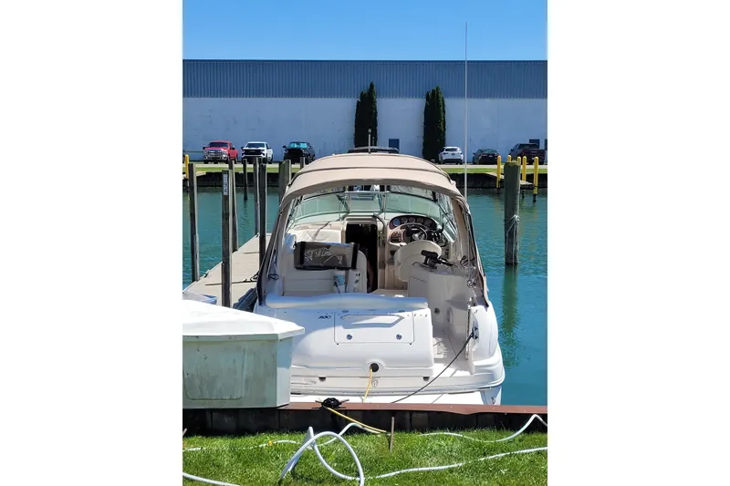 Slide: The Image of 2004 Searay 280 Sundancer docked at marina with clear blue water. - 19