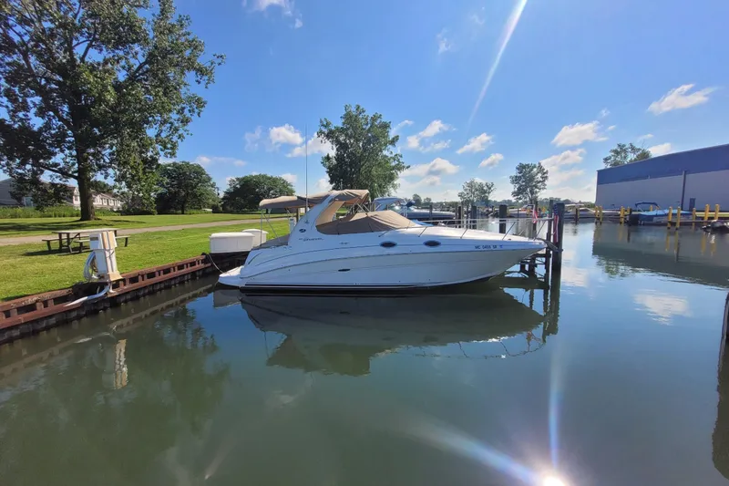 Slide: The Image of 2004 Searay 280 Sundancer docked on a sunny day, reflecting on calm water. - 21