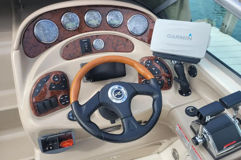 Slide: The Image of 2004 Searay 280 Sundancer helm with Garmin GPS, wood accents, and Mercury controls. - 9