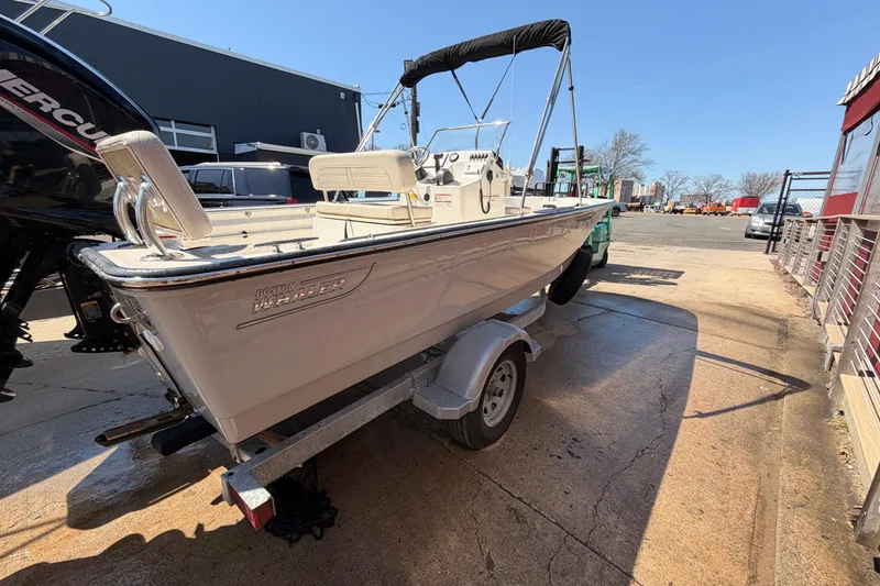 Slide: The Image of 2024 Boston Whaler 170 Montauk boat on trailer, parked outdoors. - 4