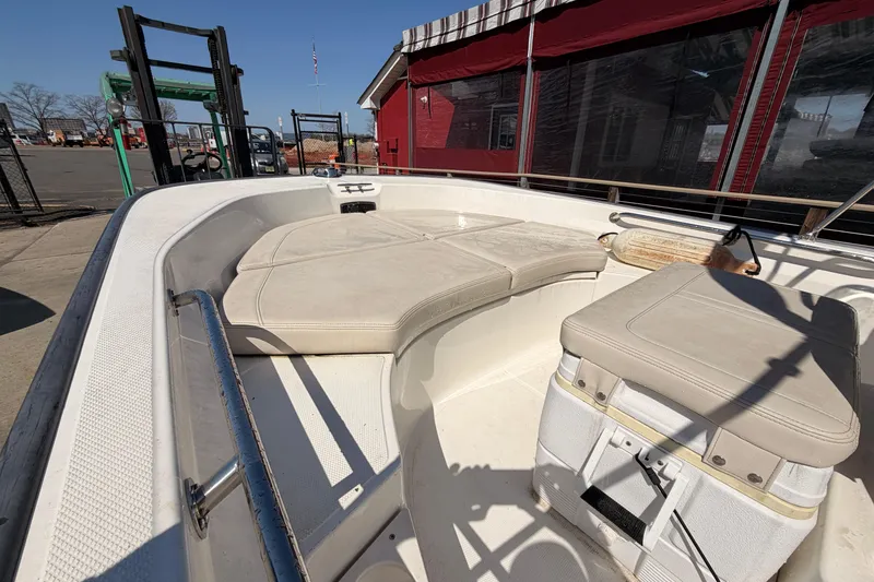 Slide: The Image of 2024 Boston Whaler 170 Montauk boat interior with cushioned seating and storage. - 5