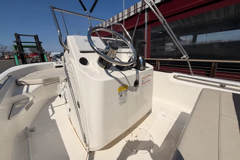 Slide: The Image of 2024 Boston Whaler 170 Montauk boat interior with steering console and seating. - 6