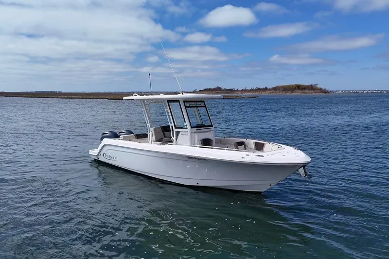 Slide: The Image of 2020 Robalo R272 Center Console boat on calm water under blue sky. - 10